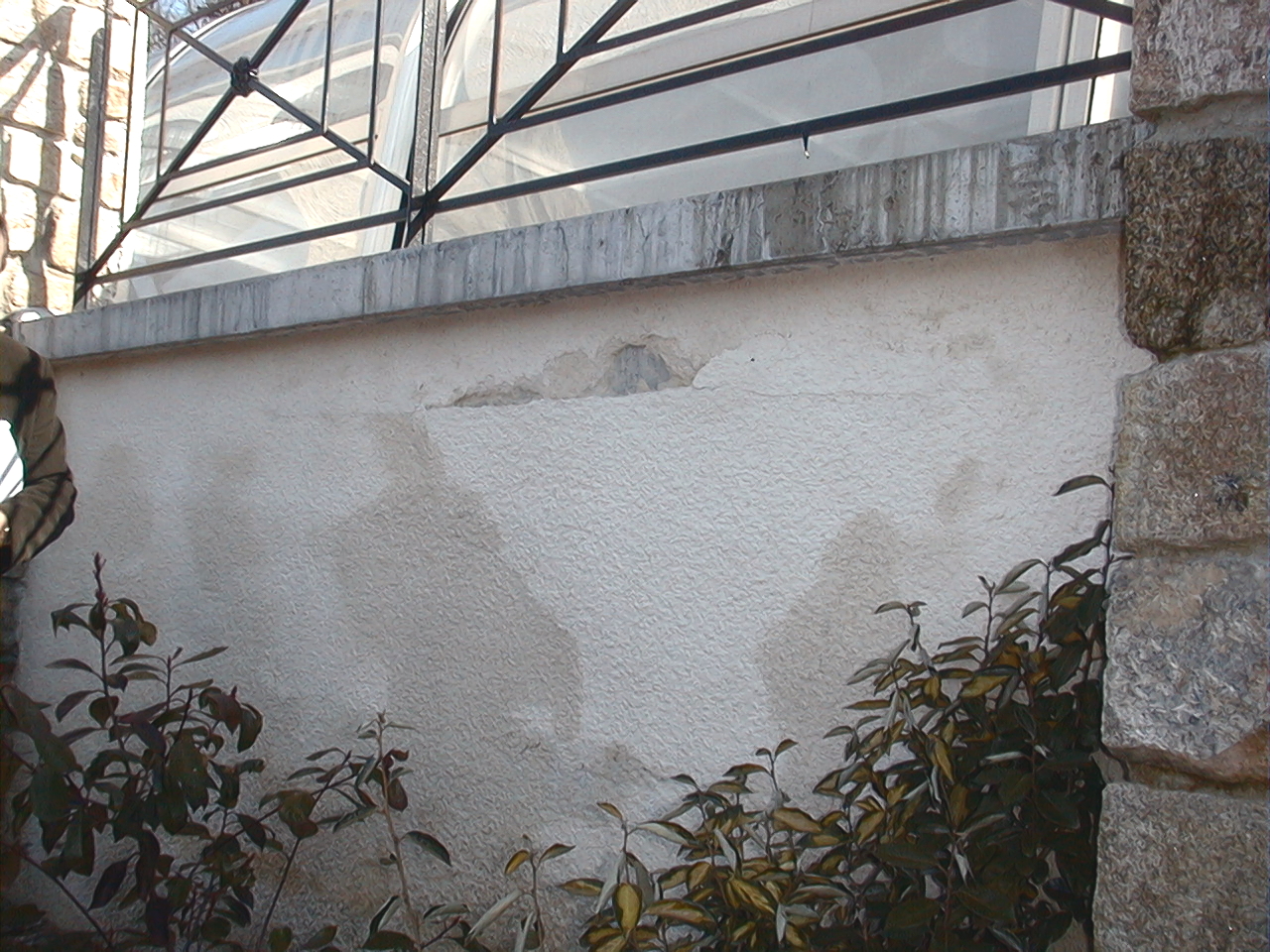 L’enduit appliqué sur la face extérieure du mur de la piscine présente des fuites et infiltrations d'eau